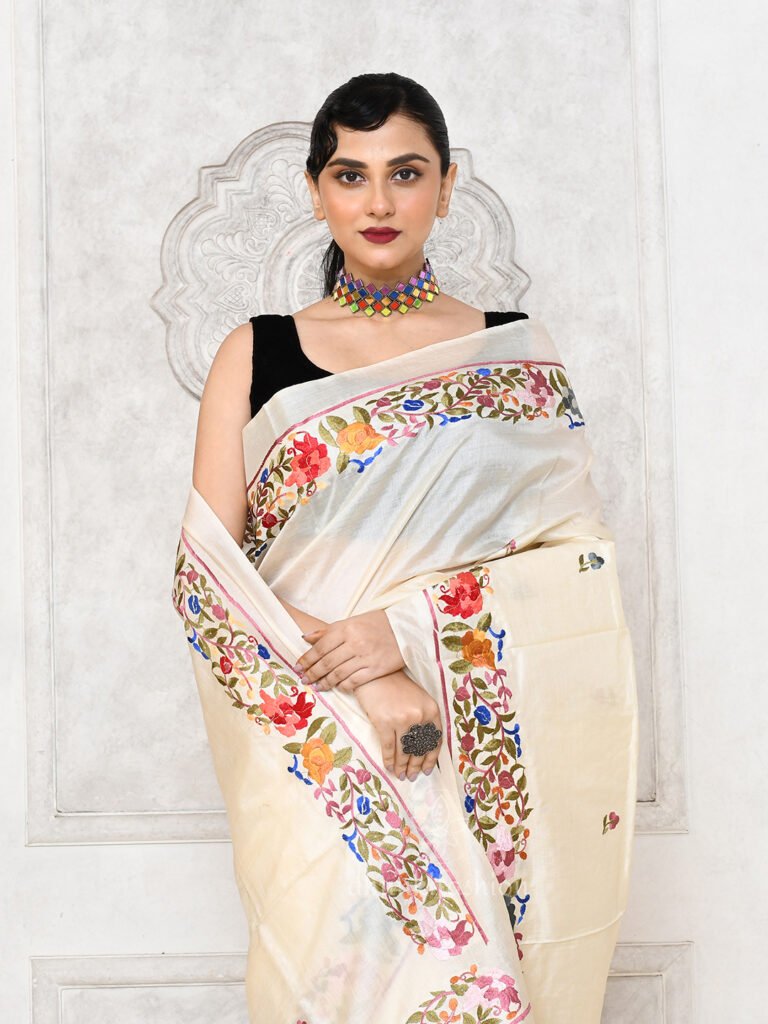 woman in cream tussar silk floral embroidered saree